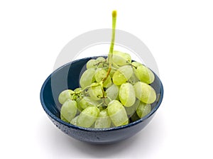 Bunch of green grapes in a plate isolated on white background