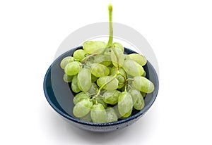 Bunch of green grapes in a plate isolated on white background