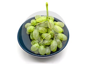 Bunch of green grapes in a plate isolated on white background