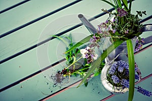 Bunch of herbs and flowers in metal watering can