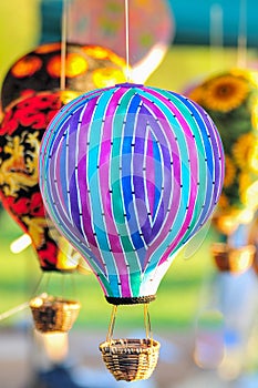 Bunch of hot air balloon toys dangling in the wind