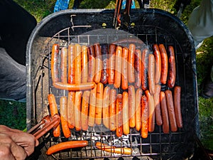 Bunch of hotdogs on bbq grill