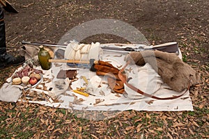 Bunch of hunting and trapping equipment on a sheet in a forest