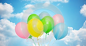 Bunch of inflated helium balloons over blue sky