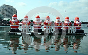 A bunch of inflated Santa Claus are decorating the Darling Harbour