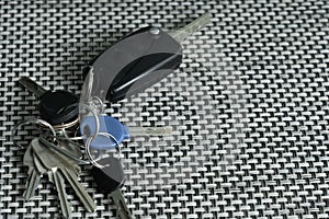 a bunch of keys - car bike and apartment keys on texture table