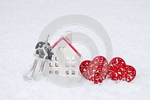 A bunch of keys of house and two hearts in snow - Valentine`s Day, love in home. Couple housing, real estate, rent, mortgage, rel