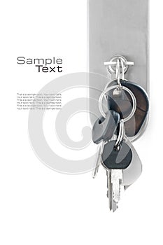 Bunch of keys at the lock of a front door, isolated on white