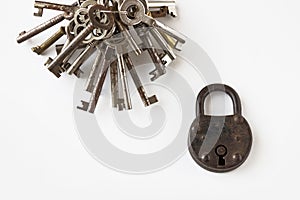 Bunch of keys and old padlock on white background