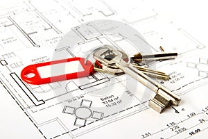 Bunch of keys with red keychains at building drawing photo