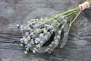 Bunch of lavender flowers on gray wooden background. Close-up, top view