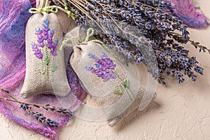 Bunch of lavender flowers and sachets filled with dried lavender.