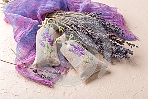 Bunch of lavender flowers and sachets filled with dried lavender.