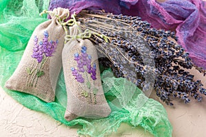 Bunch of lavender flowers and sachets filled with dried lavender.