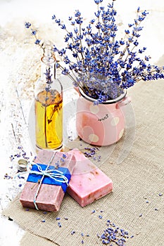 Bunch of lavender flowers,soap on old wooden background.Spa tre
