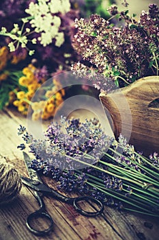 Bunch of lavender, thyme flowers in wooden box and healing herbs.