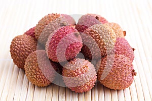 Bunch of litchis on bamboo matt