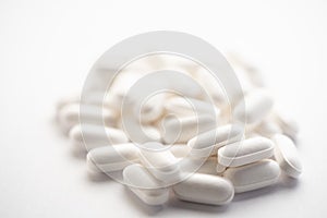 Bunch of little white zinc pills on bright white background