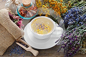 Bunch of medicinal herbs, healthy tea and bag of dry herbs. photo