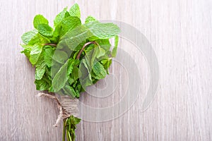 Bunch of mint on a gray wooden background