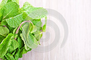 Bunch of mint on a gray wooden background close-up