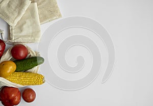 Bunch of mixed organic vegetables and empty reusable cotton bag on a table. Zero waste concept. Eco friendly lifestyle