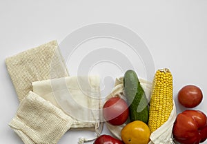 Bunch of mixed organic vegetables and empty reusable cotton bag on a table. Zero waste concept. Eco friendly lifestyle