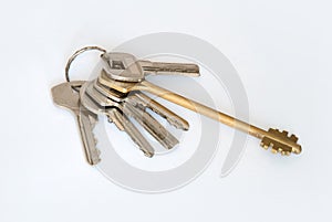 A bunch of modern door keys on ring on white background
