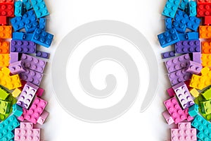 Lego. Border of A lot of Colorful Plastick constructor bricks on white background. Popular toys. Copyspace. Horizontal