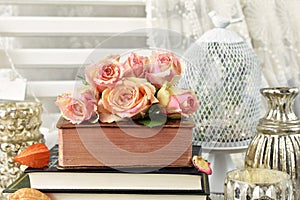 Bunch of multicolor roses lying on old book