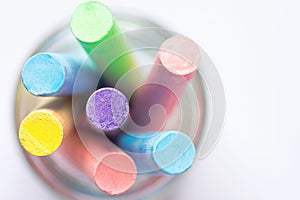 Bunch of Multicolored Chalks Crayons in Pencil Cup. Top View White Background. Education Arts Crafts Creativity