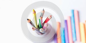 Bunch of Multicolored CPencils in Cup Chalks. Top View White Background. Education Arts Crafts Creativity Concept. Banner