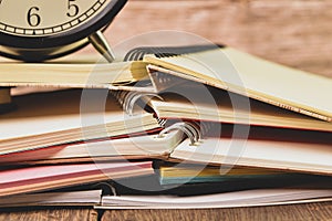 Bunch of notebooks and alarm clock. Conceptual image