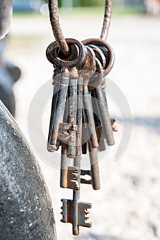 A bunch of old rustic keys. Outdoors.