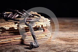 Bunch of old vintage keys with books on wooden table