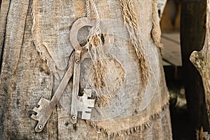 A bunch of old wooden keys hanging on a rope, close-up