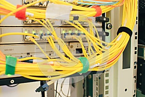 A bunch of optical Internet cables connected to the main router. Powerful network equipment located in the server room datacenter