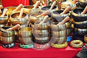 Bunch of piled Hinduist tibetan singing bowls for wellness practices