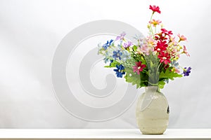 Bunch of plastic flowers in vase