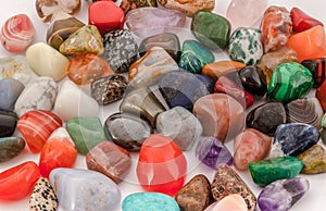 A bunch of polished gemstones, close-up. High-angle view. Colorful gemstones background.