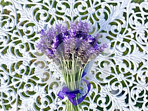 A bunch of purple French lavender tied with a purple bow. Cool tone.