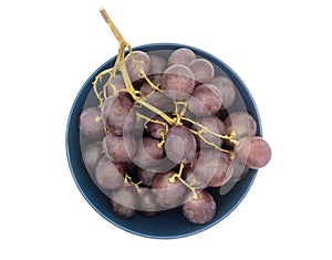 Bunch of purple grapes in a plate isolated on white background