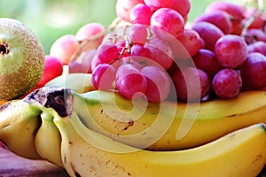 Bunch of red grapes and bananas