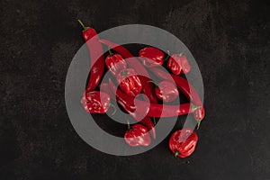 Bunch of red peppers on a black slate