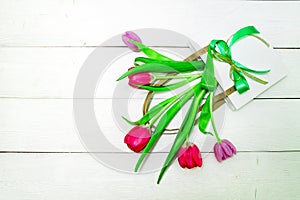 Bunch of red and purple tulips on white wooden background with copy space like postcard on womens day