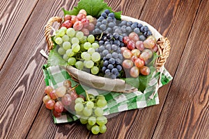 Bunch of red, purple and white grapes in basket