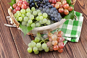 Bunch of red, purple and white grapes in basket