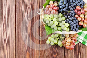 Bunch of red, purple and white grapes in basket
