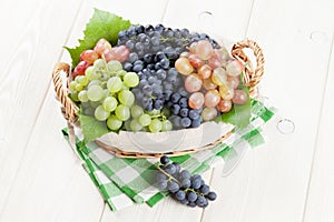 Bunch of red, purple and white grapes in basket