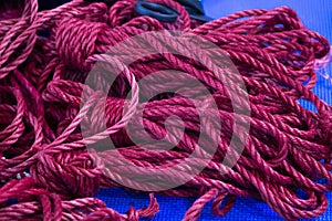 bunch of red ropes for shibari at a bdsm meeting for training